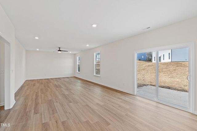 spare room featuring ceiling fan and light hardwood / wood-style floors