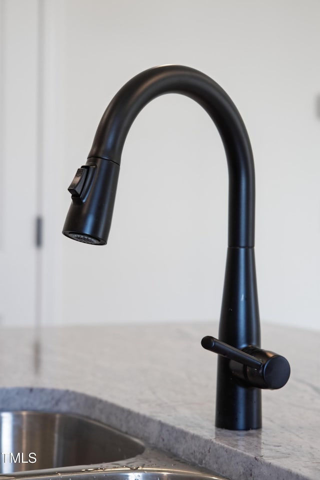 details featuring sink and stone countertops