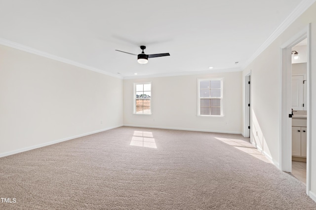 unfurnished room with crown molding, light carpet, and ceiling fan