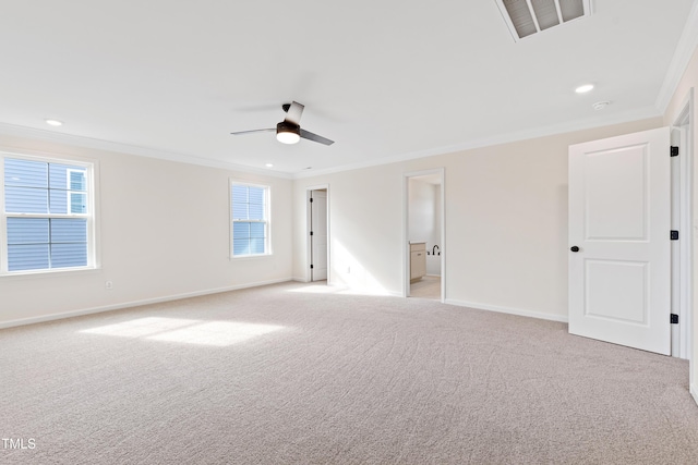 spare room featuring crown molding, light carpet, and ceiling fan