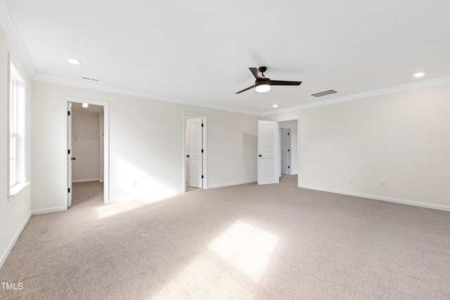 carpeted spare room with crown molding and ceiling fan