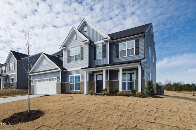 craftsman house with a garage and central AC