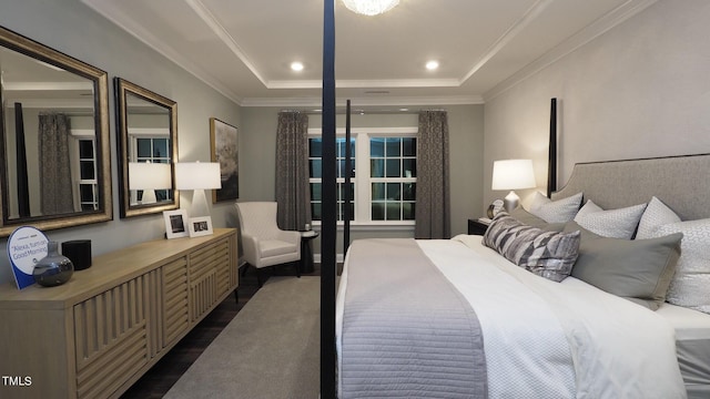 bedroom featuring ornamental molding, dark hardwood / wood-style floors, and a tray ceiling