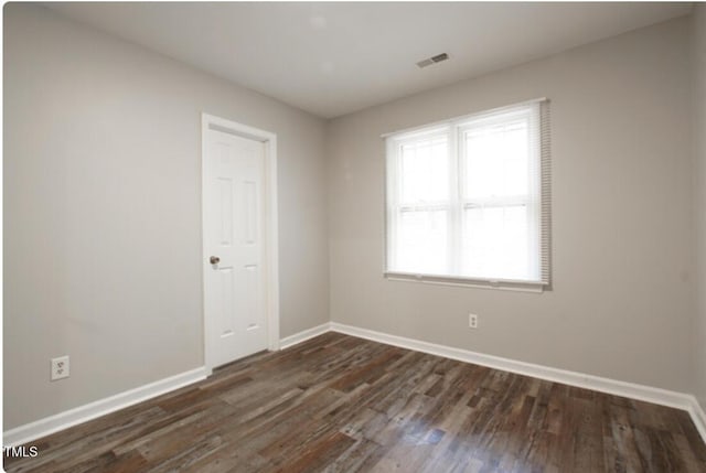 unfurnished room featuring dark hardwood / wood-style floors