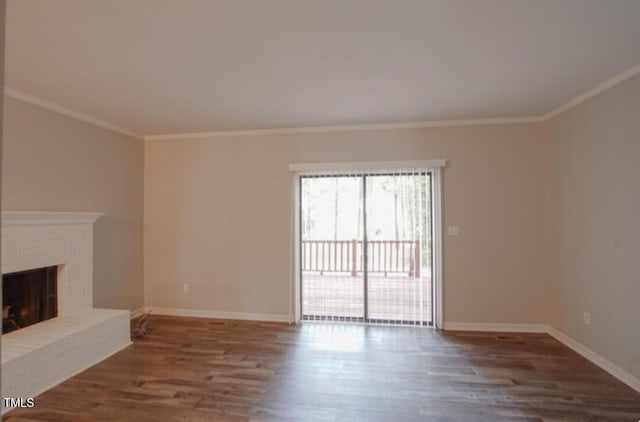 unfurnished living room with dark hardwood / wood-style flooring, crown molding, and a fireplace