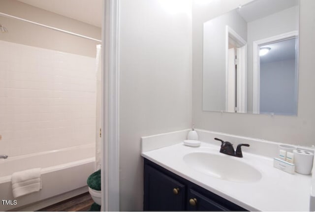 full bathroom featuring vanity, washtub / shower combination, and toilet