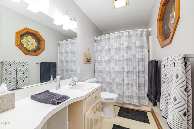 bathroom with vanity, toilet, and curtained shower