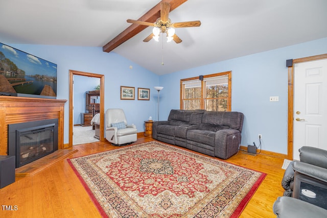 living room with ceiling fan, lofted ceiling with beams, and hardwood / wood-style floors