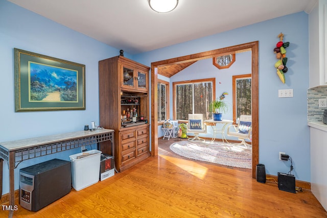 foyer entrance featuring lofted ceiling and light hardwood / wood-style flooring