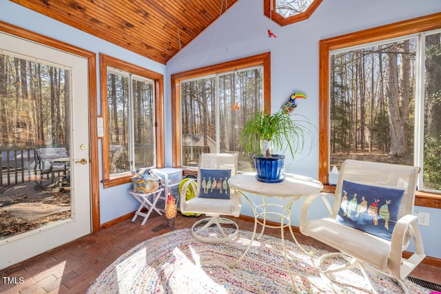 sunroom with vaulted ceiling, a wealth of natural light, and wood ceiling