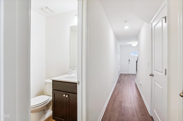 hall featuring sink and dark hardwood / wood-style floors