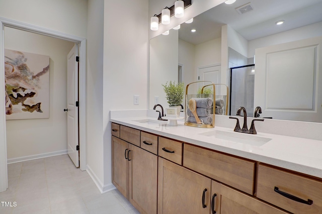 bathroom featuring tile patterned flooring, vanity, and walk in shower