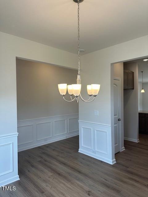 142 Vega Loop, Sanford, NC 27330 - unfurnished dining area with a chandelier, dark wood-style floors, wainscoting, and a decorative wall