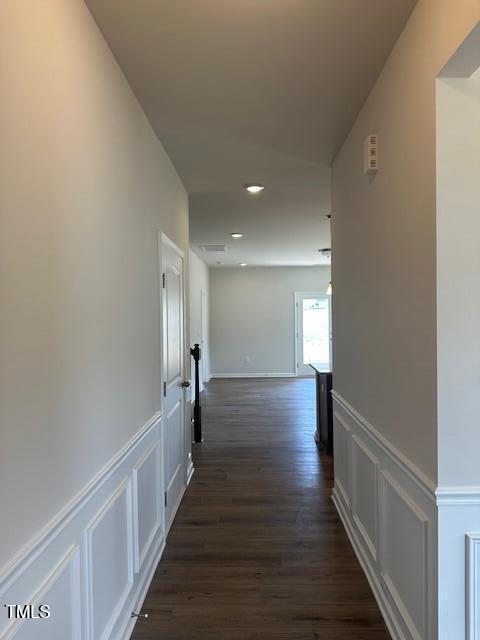 142 Vega Loop, Sanford, NC 27330 - hall featuring dark wood-style flooring, a decorative wall, a wainscoted wall, and recessed lighting