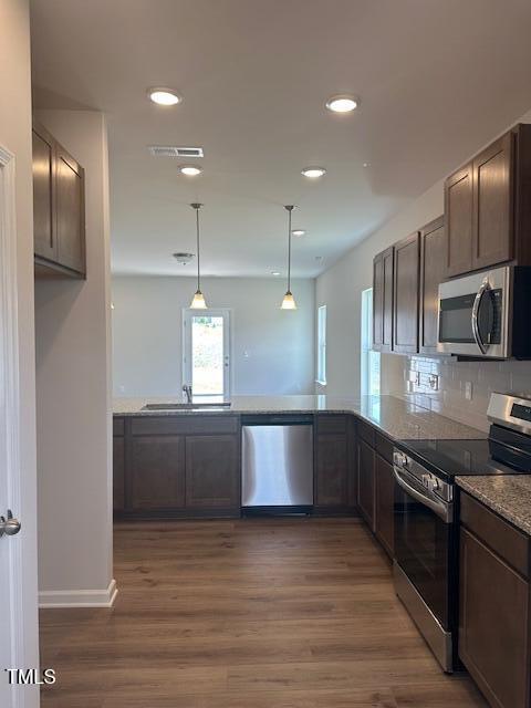 142 Vega Loop, Sanford, NC 27330 - kitchen featuring appliances with stainless steel finishes, a sink, dark wood-type flooring, recessed lighting, and hanging light fixtures