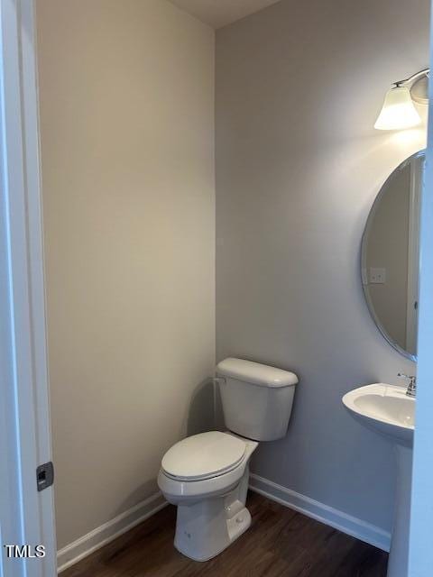 142 Vega Loop, Sanford, NC 27330 - bathroom with wood finished floors, toilet, and baseboards