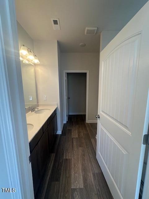 142 Vega Loop, Sanford, NC 27330 - bathroom with wood finished floors, double vanity, and baseboards