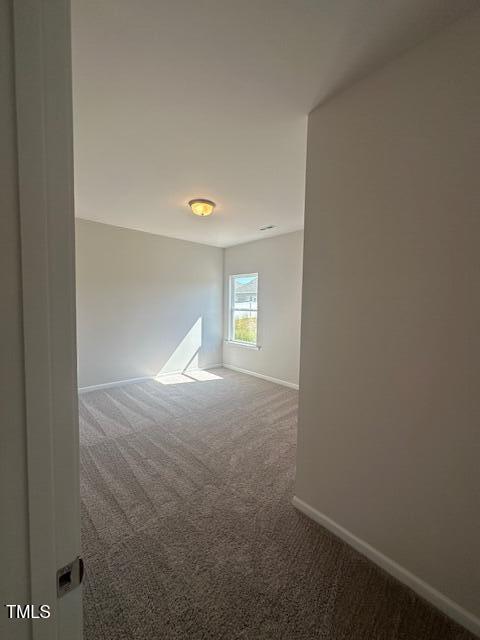 142 Vega Loop, Sanford, NC 27330 - spare room with carpet and baseboards