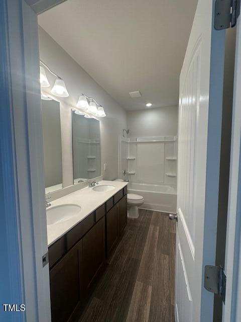 142 Vega Loop, Sanford, NC 27330 - bathroom with wood finished floors, toilet, shower / washtub combination, and double vanity