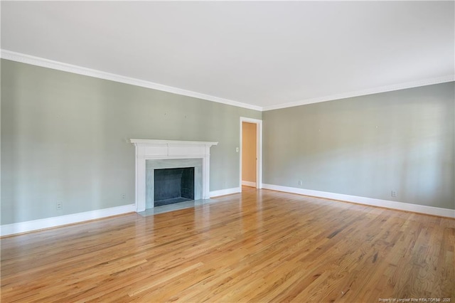 unfurnished living room with crown molding and light hardwood / wood-style flooring