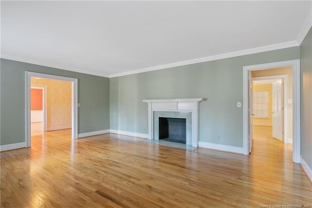 unfurnished living room with crown molding and light hardwood / wood-style floors