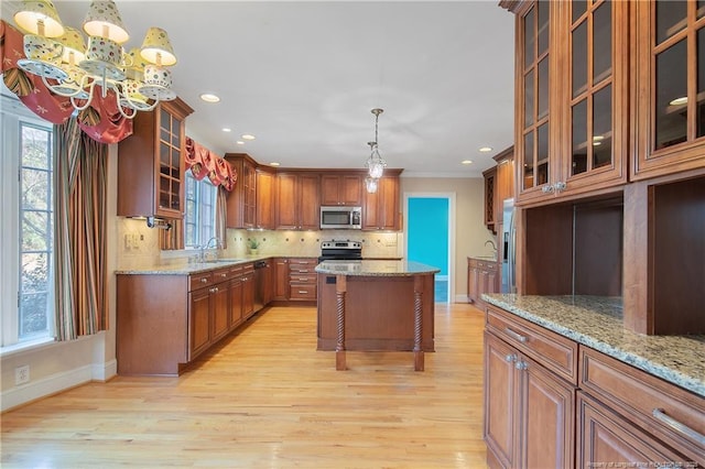 kitchen with light stone countertops, appliances with stainless steel finishes, and sink