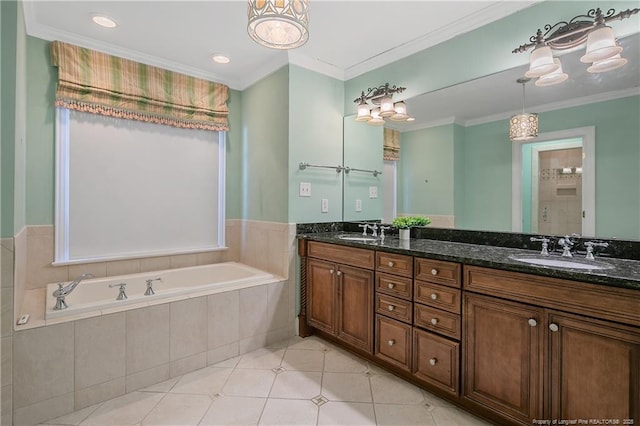 bathroom with tiled tub, vanity, ornamental molding, and tile patterned floors