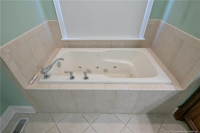 bathroom featuring tile patterned flooring and a relaxing tiled tub