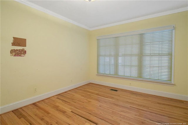 unfurnished room with crown molding and light hardwood / wood-style flooring