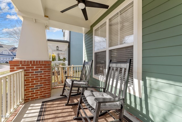 balcony with a porch and ceiling fan