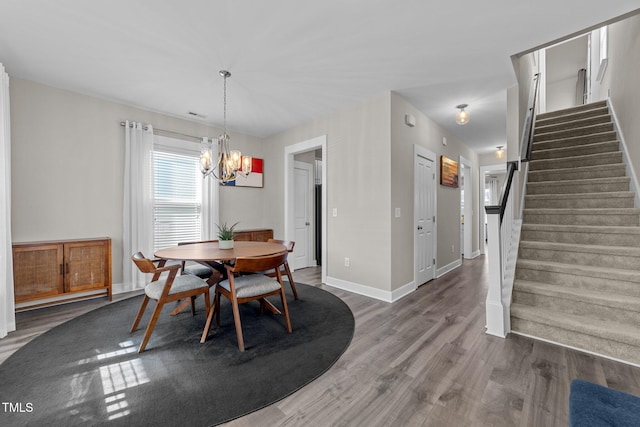 dining area featuring hardwood / wood-style flooring and an inviting chandelier