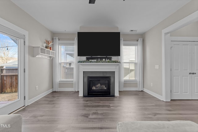 unfurnished living room with a healthy amount of sunlight and light wood-type flooring