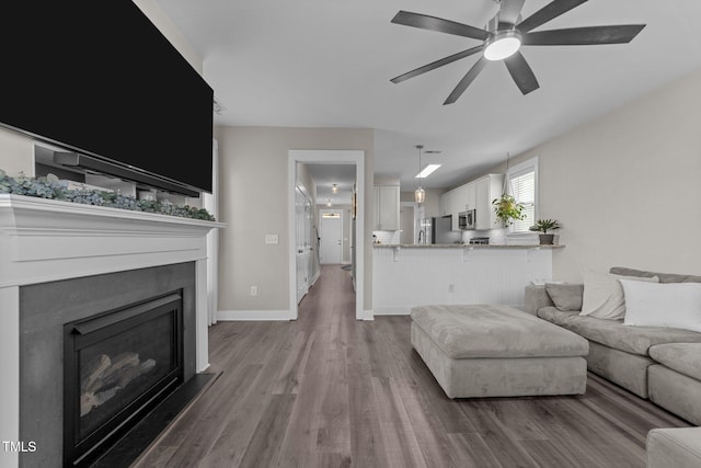 living room with wood-type flooring and ceiling fan