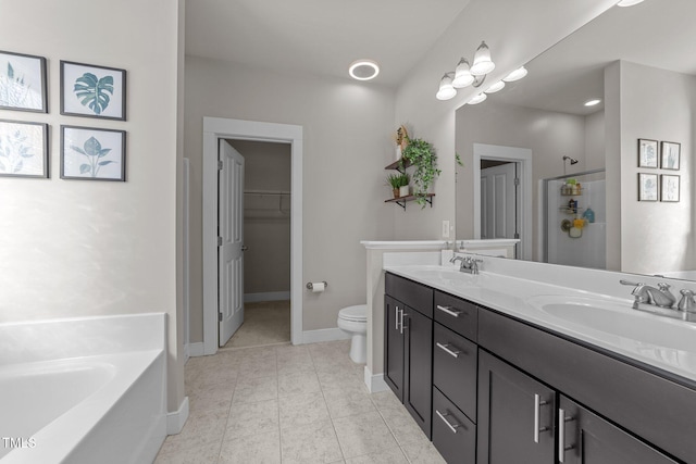 full bathroom featuring vanity, tile patterned floors, shower with separate bathtub, and toilet