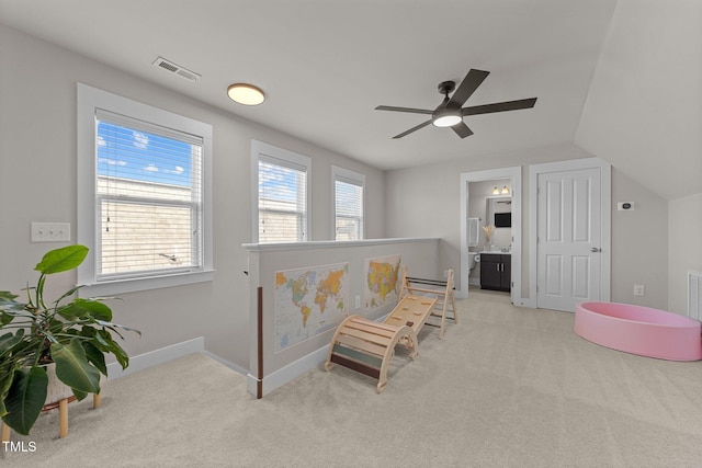 sitting room featuring vaulted ceiling and light carpet