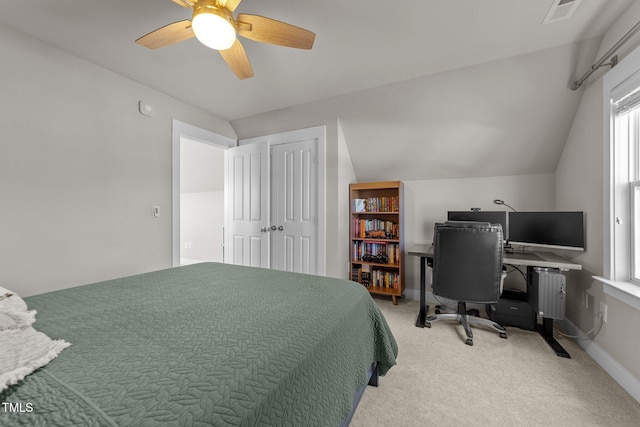 bedroom featuring radiator, ceiling fan, carpet, vaulted ceiling, and a closet