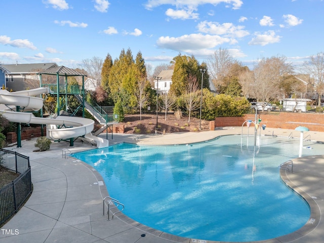 view of pool featuring a playground and a water slide