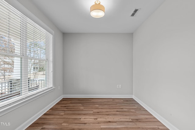 unfurnished room with hardwood / wood-style floors