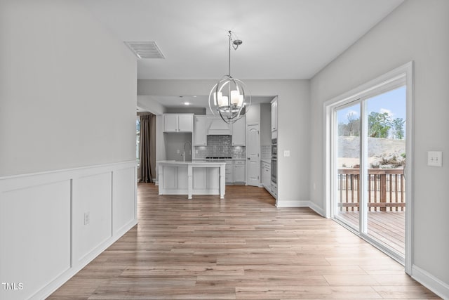 interior space featuring a notable chandelier, light hardwood / wood-style flooring, and sink