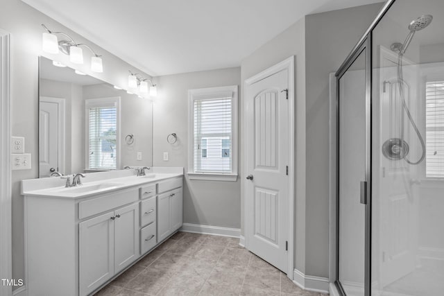 bathroom featuring vanity, tile patterned flooring, and a shower with shower door