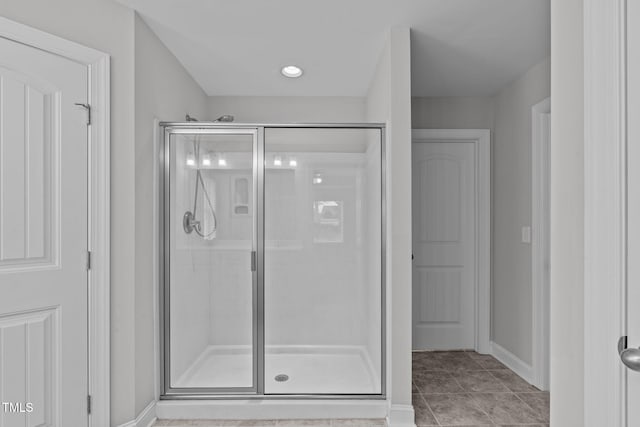 bathroom featuring a shower with shower door