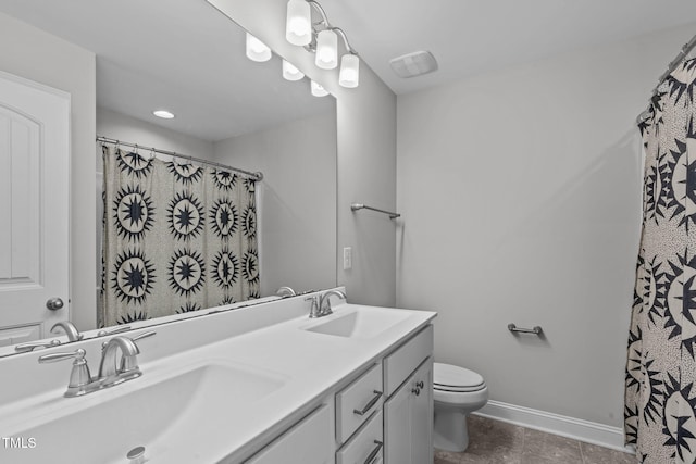 bathroom featuring vanity, toilet, and curtained shower