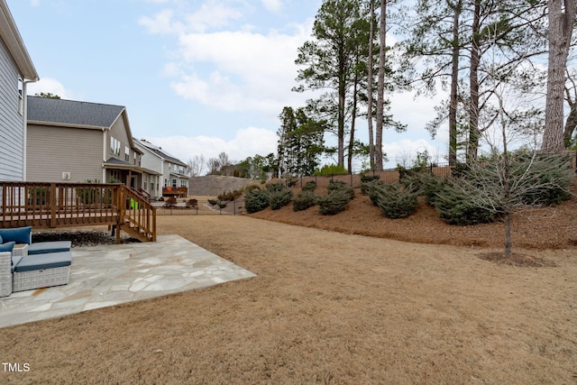 view of yard with a wooden deck and a patio