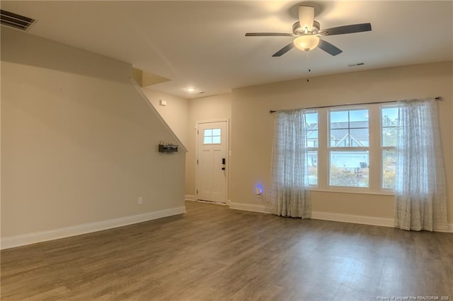 interior space with dark hardwood / wood-style floors and ceiling fan