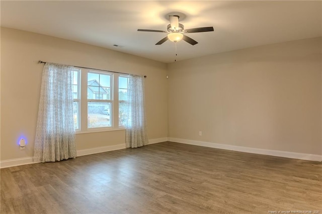 unfurnished room featuring ceiling fan and wood-type flooring