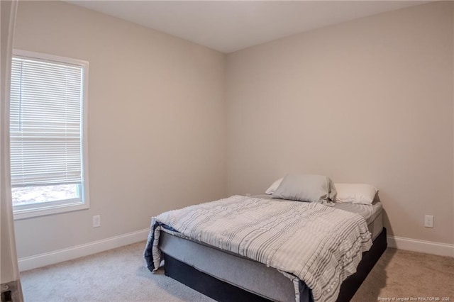 bedroom featuring light carpet