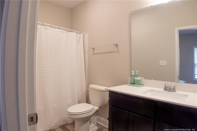 bathroom with hardwood / wood-style flooring, vanity, and toilet