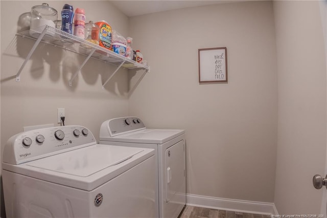 laundry area featuring independent washer and dryer and wood-type flooring