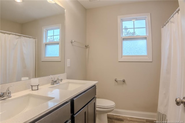 bathroom with vanity, hardwood / wood-style floors, and toilet