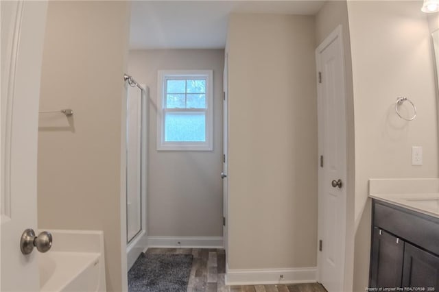 bathroom featuring hardwood / wood-style flooring, vanity, and independent shower and bath